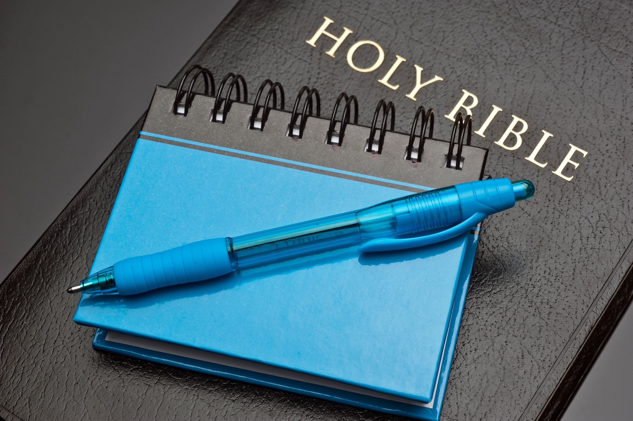 Bible with notepad and pen